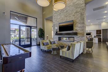 Clubhouse featuring a floor to ceiling fireplace, flat screen tvs